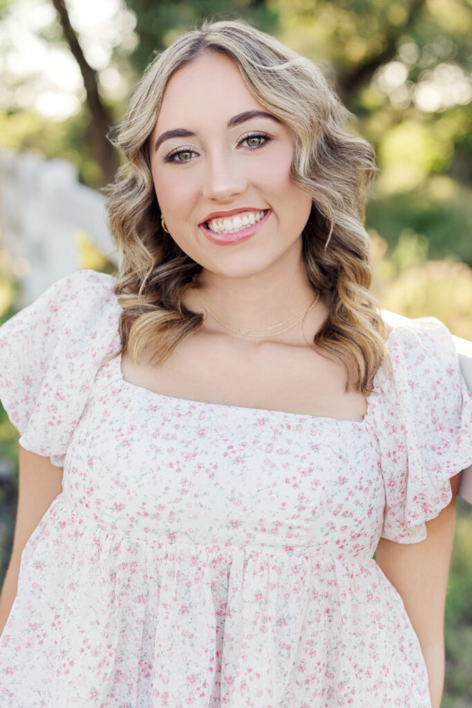 Brooklyn, a Round Rock Christian Academy senior and LGMD advocate, smiling during her senior photo session with Jaclyn May Photography in Round Rock, Texas.