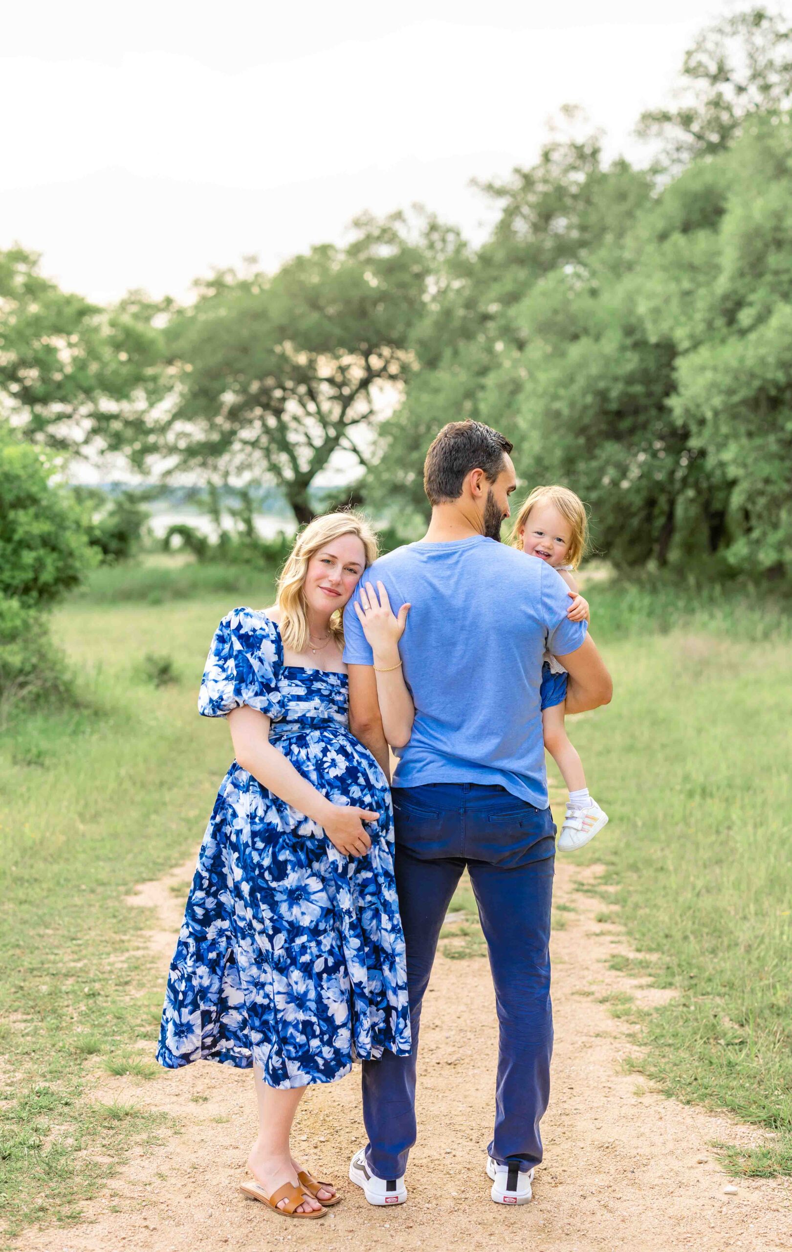 Luxury maternity photoshoot in Liberty Hill with mom in blue floral dress and joyful toddler